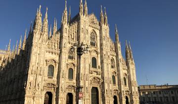 Front view of the Milan Cathedral with clear blue skies.