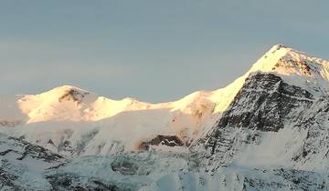 Sunlight hitting snowy mountain peaks
