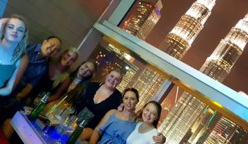 Group at night with illuminated towers in the background.