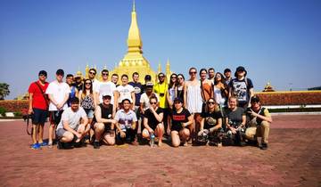 Large group in front of a golden stupa.