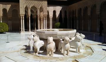 Stone fountain with lion statues in a courtyard.