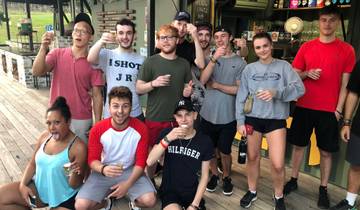 Group having drinks on a wooden deck.