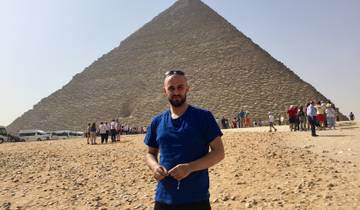 A man standing in front of the Great Pyramid of Giza.