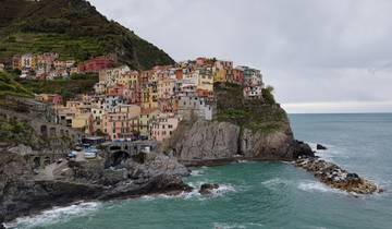 Colorful houses on a cliff overlooking the sea in a coastal village.