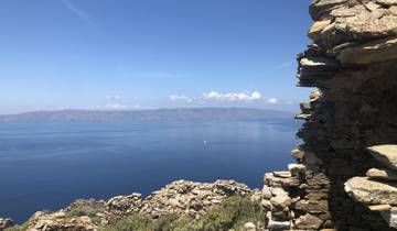 View of a blue sea with distant mountain ridges.