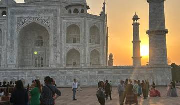 Visitors at the Taj Mahal during sunset.