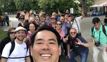 Large group of people smiling for a selfie in an outdoor setting.