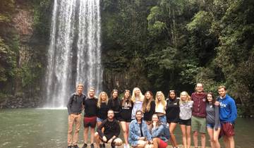 Large group posing in front of a waterfall.