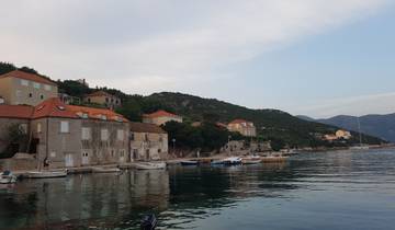 Small coastal village with boats by the shore.