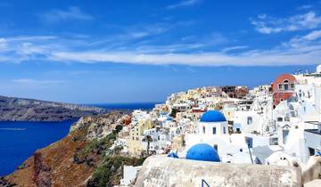 Iconic view of Santorini with blue domed churches and sea.