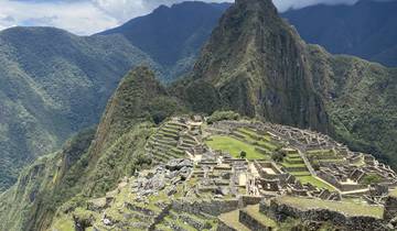 Panoramic view of Machu Picchu with mountains in the background.