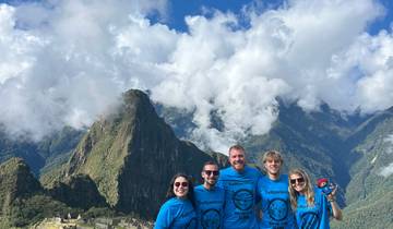 Group of tourists with Machu Picchu in the background.
