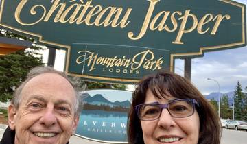 Couple posing in front of the Chateau Jasper sign.