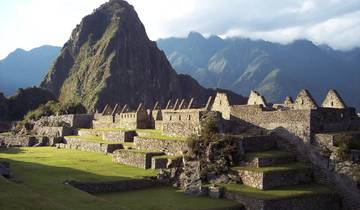 Sprawling Incan structures with mountain backdrop.