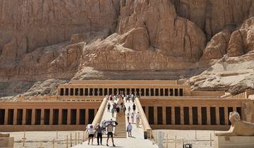 An ancient Egyptian temple with a mountain backdrop.