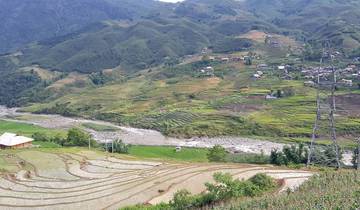 Terraced fields in a valley with distant mountains.