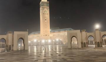 A large mosque lit up at night.