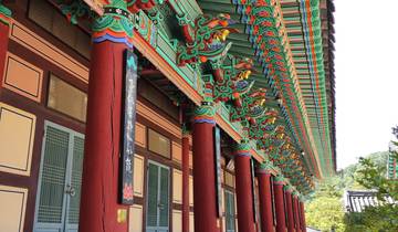 Colorful traditional architecture with intricate designs on beams.