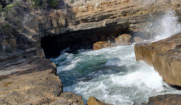 Rocky coastal scenery with a waterfall.