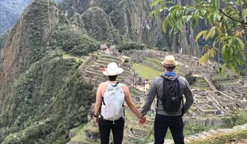 Couple holding hands overlooking Machu Picchu.