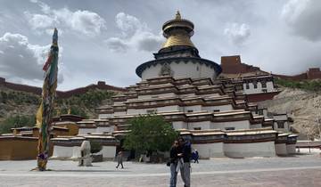 Two people standing in front of a large temple