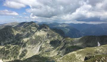 Mountain range under a partly cloudy sky.