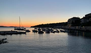 Serene sunset over a harbor with boats.