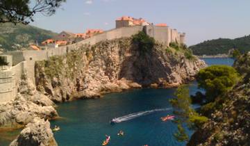Rocky coastline with fortifications overlooking the sea.