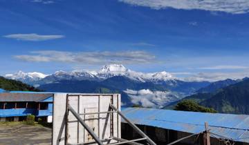 Mountain range with snow-capped peaks in the background under a clear blue sky.