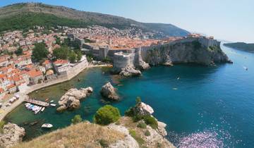 Aerial view of a city with fortifications by the sea.