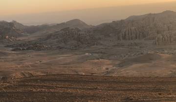 Vast desert landscape view during sunset.
