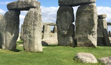 Stonehenge during a sunny day with blue sky and clouds