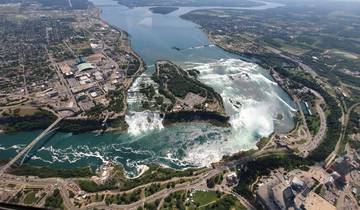 Aerial view of Niagara Falls surrounded by a cityscape.