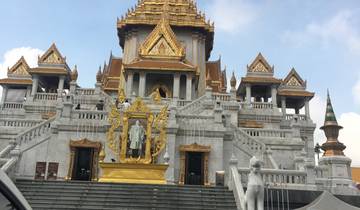 Ornate temple structure with gold details and statues.