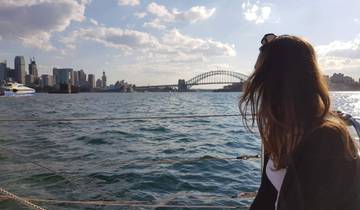 View of Sydney Opera House and Harbour Bridge from a boat.