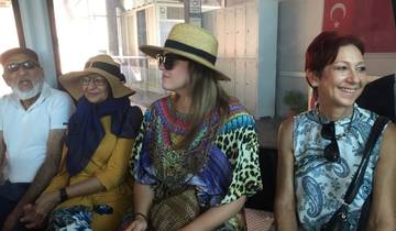 Group of people sitting together wearing hats.