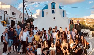 Large group of people posing in front of a blue-domed church.