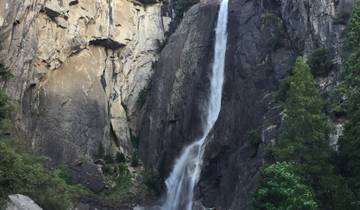 Tall waterfall descending down a steep rock face