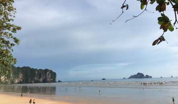 Beach with distant islands and people on the shore.