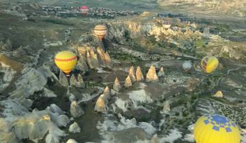 Hot air balloons flying over unique rock formations