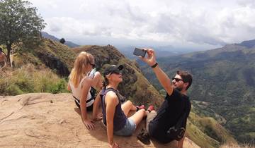 Group of people taking a selfie on a mountain cliff.