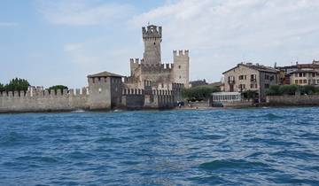 A scenic view of a historic castle by the water.
