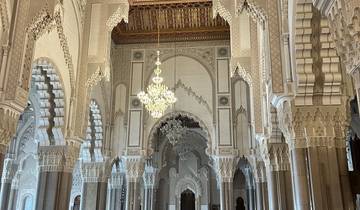 Elaborate interior of a mosque with chandeliers and ornate ceilings.