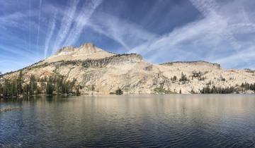 Lake with mountains and clouds reflected on its surface