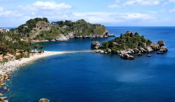 A coastal landscape with rocky islets and clear blue waters.