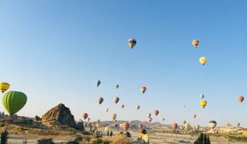 Numerous hot air balloons in the sky over Cappadocia.