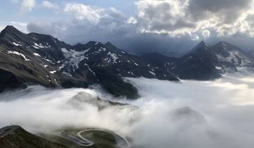 A scenic view of mountains partially covered by clouds.