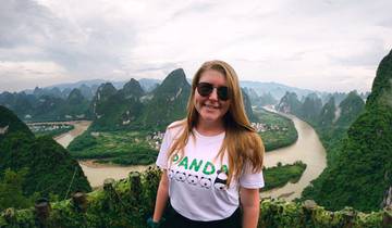 Woman posing with karst landscape in the background.