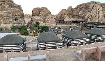 Traditional Bedouin encampment in a rocky area.