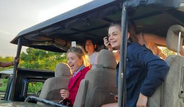 Happy tourists enjoying a wildlife safari ride.